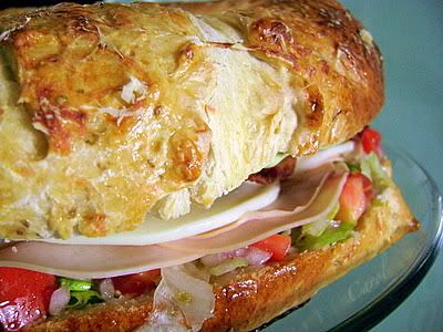 /><br/> <br/> <br/> TURKEY CLUB SANDWICH RING WITH AVOCADO AIOLI<br/> (Source: Pillsbury-recipe by Heather Halonie from Webster, WI)<br/> <br/> 2 (11 oz. each) cans refrigerated crusty French bread<br/> 1 egg<br/> 1 tsp. dried oregano, divided<br/> 1 Tbsp. shredded Parmesan cheese<br/> 1 1/2 c. shredded lettuce<br/> 1/4 c. chopped red onion<br/> 2 medium plum (Roma) tomatoes, chopped<br/> 1/4 c. extra-virgin olive oil<br/> 1 1/2 Tbsp. red wine vinegar<br/> 1/2 tsp. crushed red pepper flakes<br/> 1/2 c. mayonnaise or salad dressing (I use reduced-fat mayonnaise)<br/> 2 cloves garlic, finely chopped<br/> 1/2 avocado, pitted, peeled and chopped<br/> 1/8 tsp. black pepper<br/> 8 oz. thinly sliced deli turkey<br/> 8 slices (3/4 oz. each) provolone cheese, halved<br/> 8 slices bacon, crisply cooked (I use low sodium bacon)<br/> <br/> Heat oven to 350 degrees. Spray a large cookie sheet with nonstick cooking spray (I use my pizza pan) or line with parchment paper.<br/> <br/> Place both loaves of bread down, seam sides down, on cookie sheet. Join ends of loaves to form an 11